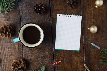 Christmas background with small notebook, decorations and cup coffee