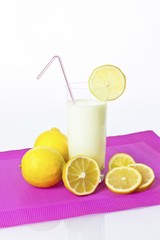 Lemon drinking yoghurt, lemon shake in a glass and lemons