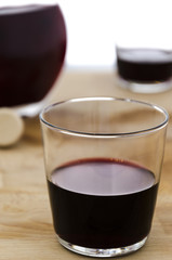 the red glass of wine, still life with a glass of red wine and bottle on the background. luxury. relax.
