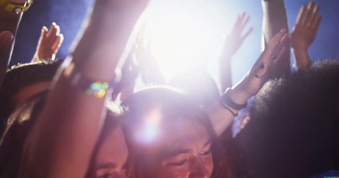 Group of people dancing at a concert 