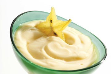 Vanilla pudding with carambola in a glass bowl