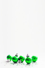 Christmas and New Year background with green decorative balls for Christmas tree. Place for text.