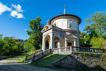 Sacro Monte of Varese (Santa Maria del Monte), Italy. Via Sacra that leads to medieval village, with the seventh chapel. In the background the village of Sacro Monte. World Heritage Site - Unesco - obrazy, fototapety, plakaty