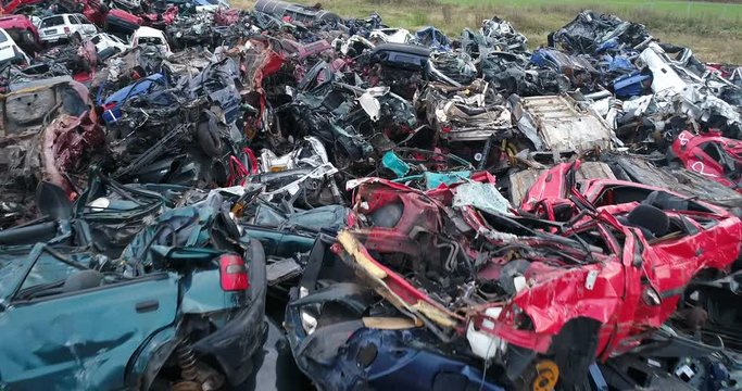 Crushed corroded old cars stacked in scrapyard. Car recycling