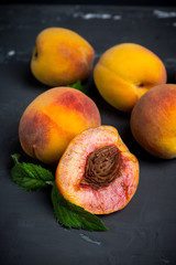 Fresh peaches on the rustic background. Shallow depth of field.