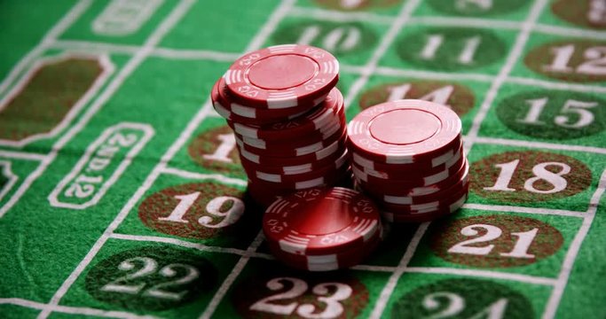 Casino chips on roulette on poker table 