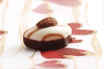 Almond on a chocolate, on a heart table cloth