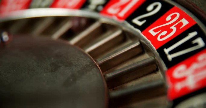 Close-up of spinning roulette wheel on poker table 