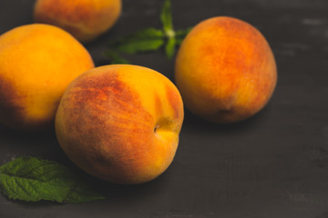 Fototapeta na wymiar Fresh peaches on the rustic background. Shallow depth of field. Toned image.