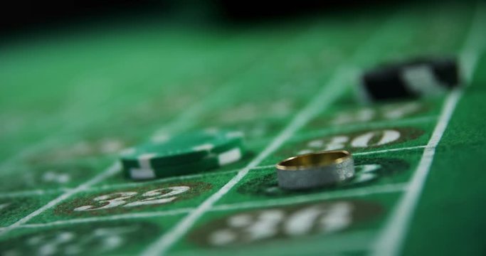 Casino chips and ring on roulette in casino 