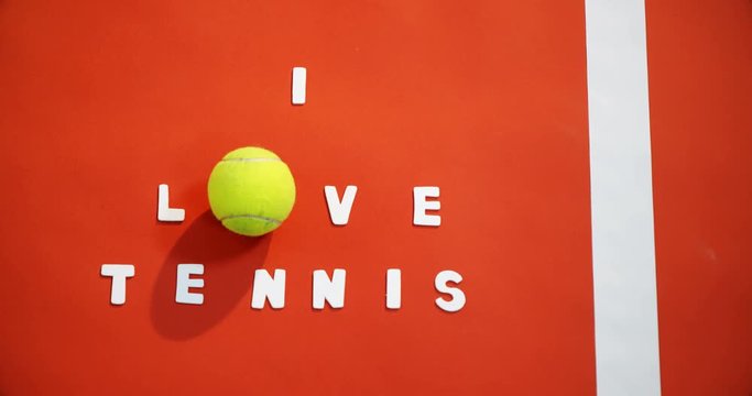 Tennis ball with I love tennis text in court 