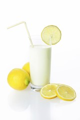 Lemon drinking yoghurt, lemon shake in a glass and lemons