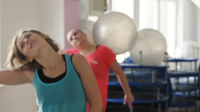 Group of women dancing zumba at fit class. Sport, lifestyle and losing weight concept. 