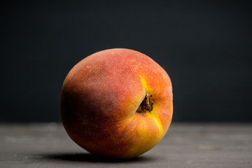 Fototapeta na wymiar Fresh peaches on the rustic background. Shallow depth of field.