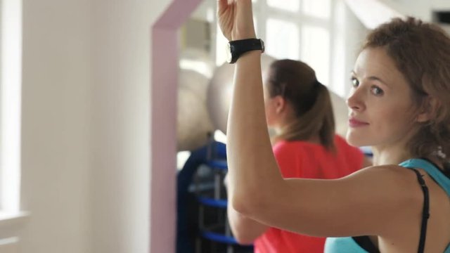 Young women dancing together at zumba class. Fitness, leisure and body improvement.  