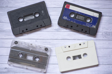 Fototapeta premium Old cassette tapes with a wooden background