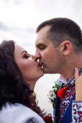 Outdoor portrait of young loving couple kissing each other