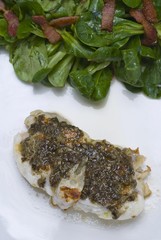 Sea-Devil fish (Lophius piscatorius) with with algae tartar and field salad (Valerianella locusta) with roasted bacon strips