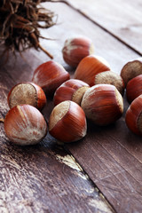 Hazelnut on wooden background. Tasty group of organic hazelnuts