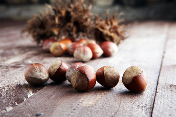 Hazelnut on wooden background. Tasty group of organic hazelnuts