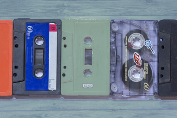 Old cassette tapes with a wooden background
