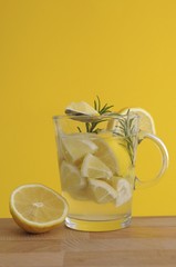Lemon pieces, rosemary, lemon juice, lemon tea, tea glass