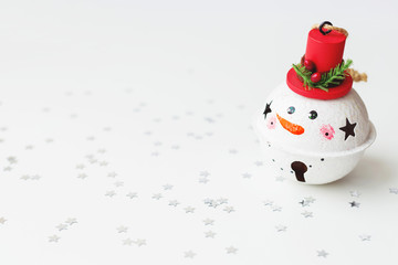Christmas and New Year background with Snowman decorative ball for Christmas tree. Holiday background with stars confetti. Place for text.