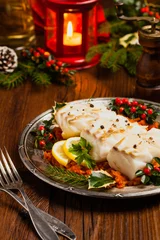 Gordijnen Christmas fish. Roasted cod pieces, served in vegetable sauce. © gkrphoto