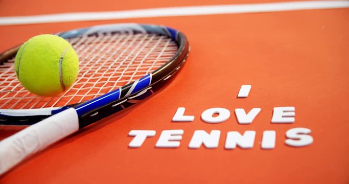 Tennis ball and racket with I love tennis text in court 