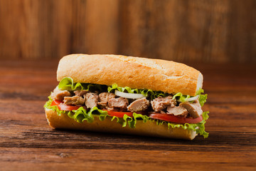 Delicious tuna sandwich, served with lettuce, tomato and onion.