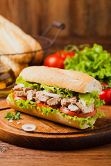Delicious tuna sandwich, served with lettuce, tomato and onion.