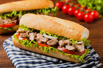 Delicious tuna sandwich, served with lettuce, tomato and onion.