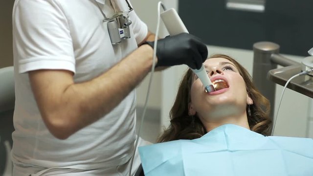 Dentist scanning the teeth of patient with a d scanner