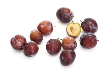 Fresh plums, whole and halved