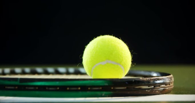 Tennis ball on racket in court 