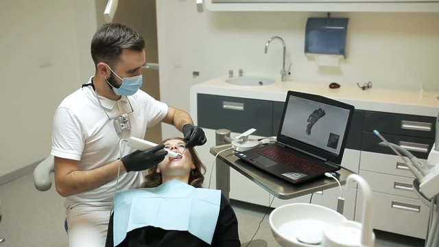 Dentist scanning the teeth of patient with a d scanner