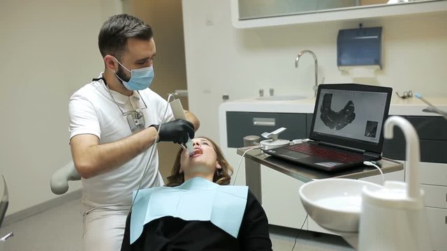Dentist scanning the teeth of patient with a d scanner