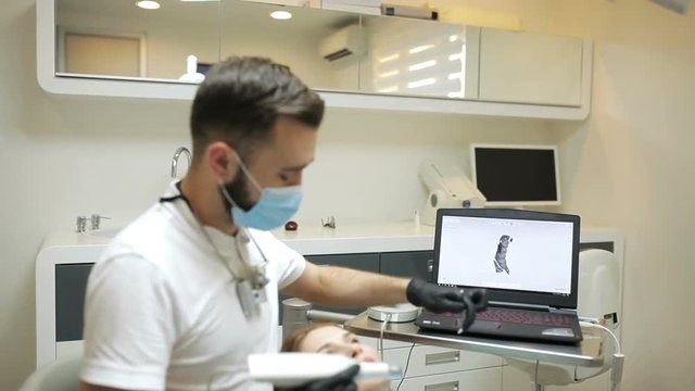 Dentist scanning the teeth of patient with a d scanner