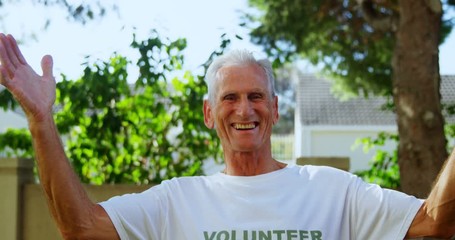 Senior volunteer having fun in garden 