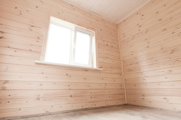 New room interior, wooden walls and window