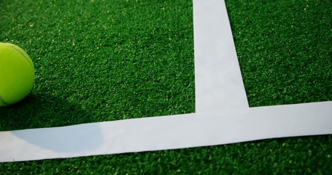 Tennis ball near white line 