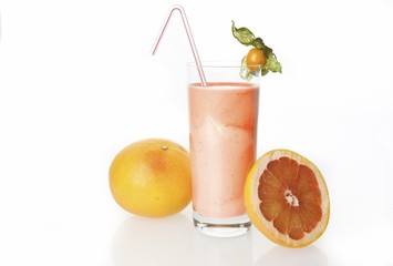 Grapefruit drinking yoghurt, grapefruits and grapefruit shake in a glass