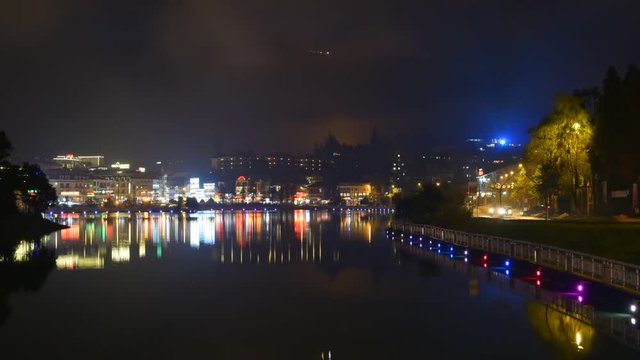 Time lapse Sapa lake on night, moving fog over mountain and water reflection,Vietnam.