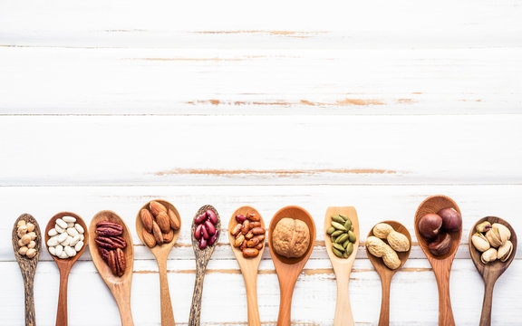 Selection food sources of omega 3 and unsaturated fats. Superfood high vitamin e and dietary fiber for healthy food. Mixed nuts almond ,pecan,hazelnuts,walnuts and various beans on white background.