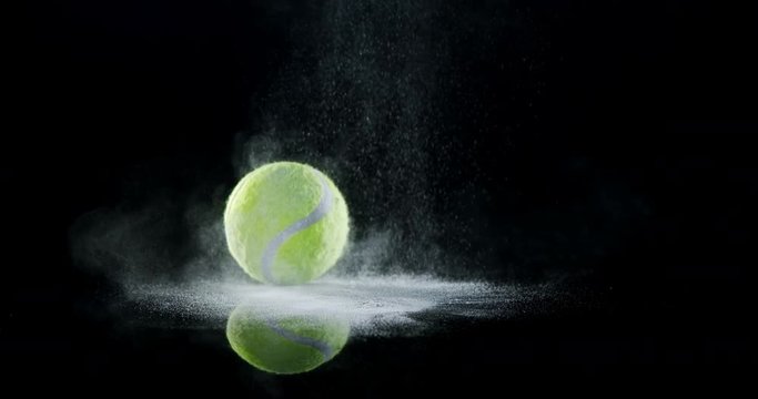 Bouncing ball with powder against black background