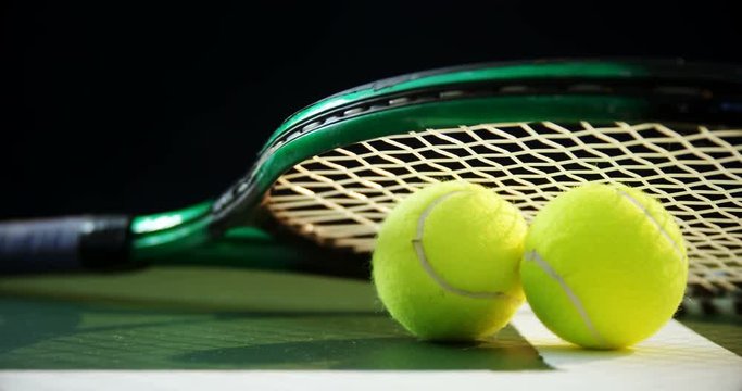 Racket and tennis balls on grass 