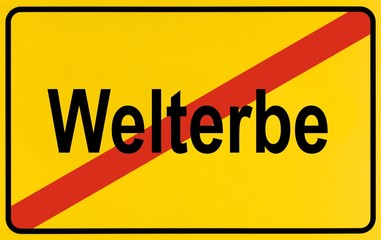 Fototapeta premium Place-name sign, place name crossed out, as a symbol for leaving a Weltkulturerbe, German for: World Heritage Site