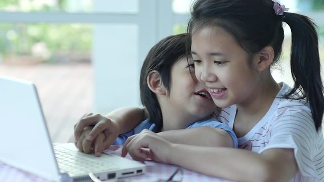 Cute Asian children using tablet together slow motion 1