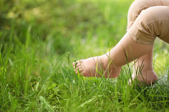 Little child and green grass in park