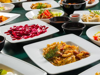 dishes with different food on the table.